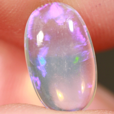 SOLID CRYSTAL OPAL Transparent with purple and green moving within